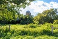 Landscape view of a pasture with grasses and a vintage farm silo Royalty Free Stock Photo