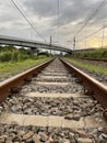 Landscape view of railroad tracks leading to infinity and overpass Royalty Free Stock Photo