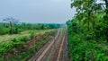 landscape view of a railway track from a bridge in middle of forest Royalty Free Stock Photo