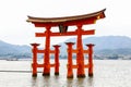 Landscape view of the red Torii gate of the Itsukushima shrine against a mountain backdrop Royalty Free Stock Photo