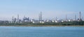 Landscape view of a refinery, storage tanks and chimneys.