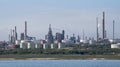 Landscape view of a refinery, storage tanks and chimneys.