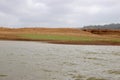 Landscape view of river bank with dry land Royalty Free Stock Photo