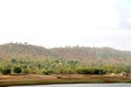 Landscape view of river bank with dry land and hill Royalty Free Stock Photo