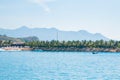Landscape, view from the sea, white beach, palm trees, mountains, boat, plane in the sky, Vietnam. five star hotel. Royalty Free Stock Photo