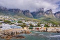 Landscape view of a seaside town along the mountain on a cloudy day in Cape Town, South Africa. Scenic view of a quiet