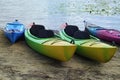 Landscape view of several colorful kayaks at the river shore. Boats on the city sandy beach, Obolon, Kyiv, Ukraine Royalty Free Stock Photo