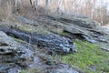 Slate Rock Cliffs Hanging Out Of The SIde Of A Mountain With A Tree Lined Background. Royalty Free Stock Photo