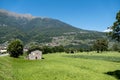 landscape view of the small stone house in the rural meadow with hills in the background Royalty Free Stock Photo