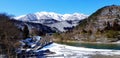 Landscape view of snow on mountain heel and ground, river or lake and clear blue sky at Shirakawago village, Japan. Royalty Free Stock Photo