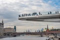 Landscape with view on soaring bridge in Zaryadye park and moscow river embankment with kremlin on background. Floating pedestrian Royalty Free Stock Photo