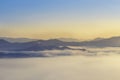 Landscape view of sunrise on high angle view with white fog in early morning over rainforest mountain Royalty Free Stock Photo