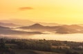 Landscape view of sunrise on high angle view with white fog in early morning over rainforest mountain Royalty Free Stock Photo