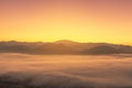 Landscape view of sunrise on high angle view with white fog in early morning over rainforest mountain Royalty Free Stock Photo