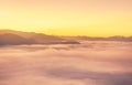 Landscape view of sunrise on high angle view with white fog in early morning over rainforest mountain Royalty Free Stock Photo