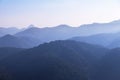 Landscape view of sunrise on high angle view with white fog in early morning over rainforest mountain Royalty Free Stock Photo