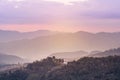 Landscape view of sunrise on high angle view with white fog in early morning over rainforest mountain Royalty Free Stock Photo