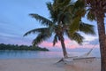 Landscape view of sunset over Muri lagoon with empty hammock in