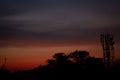 Landscape view of the sunset with trees and cellphone tower Royalty Free Stock Photo