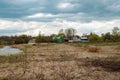 Landscape view of swampy river with fallen twisted snags and trees and village houses