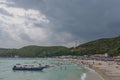 Landscape view of tawean beach with crowded of tourist on the beach in cloudy day.