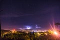 Landscape with view to the electrical storm city ligths in the starry nigth