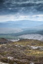 Landscape view from top of mountain on misty morning across countryside with fading layers