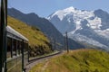 Landscape view of the train on the railways with snow-covered mountains in the background Royalty Free Stock Photo