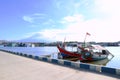 Landscape view of two traditional red and white wooden boats with Indonesian flag docked at Kejawanan Beach Pantai sea shore Royalty Free Stock Photo