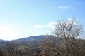 landscape view of the Ukrainian mountains with small houses, white swings and green firs and a blue sky with clouds. for postcards