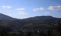 landscape view of the Ukrainian mountains with small houses, white swings and green firs and a blue sky with clouds. for postcards