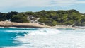 Landscape view of waves breaking over smooth granie rocks at Blue Haven Beach near Esperance in Western Australia under a bright Royalty Free Stock Photo