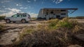 Landscape view of a 4WD vehicle and modern caravan camping next to a sandy beach