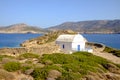 Landscape view of white chapel at beautiful ocean coastline, Greece