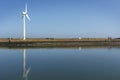 Windmill on a Harbour wall, generating electrisity Royalty Free Stock Photo