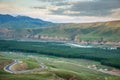 Landscape of village in mountain valley with rural road winding up Royalty Free Stock Photo