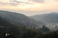 Landscape with village, mountains and mist