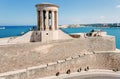 Landscape with War siege Memorial and people walking past blue sea