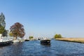 Landscape with waterways and canals of North Holland with boats, canal-side lifestyle in the Netherlands