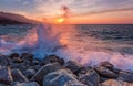 Landscape with waves crashing against coastal stones at sunrise Royalty Free Stock Photo