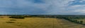 Landscape with a wheat field, wind mills and agricultural silo. Panorama of agricultural factory, wheat field in the countryside.