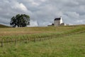 Landscape with white Corgarff Castle and a tree in Scottish landscap