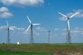 Landscape with wind farms on the background of a green field Royalty Free Stock Photo