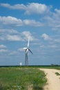 Landscape with wind farms on the background of a green field Royalty Free Stock Photo