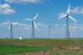 Landscape with wind farms on the background of a green field Royalty Free Stock Photo