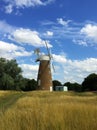 Landscape with windmill in a wheat field in Britain Royalty Free Stock Photo