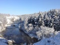 Beautiful winter impressive, inspiring landscape - trees in white snow stand on the river Bank in winter, frost