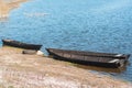 Wooden boats moored on the stone shore. there is blue water in the river