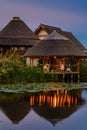 Landscape of wooden bower on the lake with water lilies in the evening