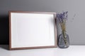 Landscape wooden frame mockup for artwork, photo and print presentation with dry laverder flowers in vase Royalty Free Stock Photo